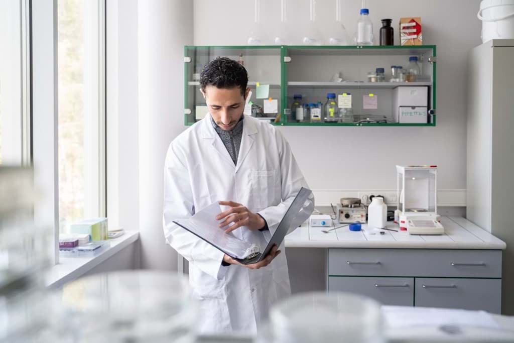 Researcher going therough notes in labjournal Researcher going therough notes in labjournal